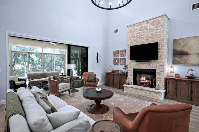 12705 Green Heron Way, Odessa, FL 33556 - living room featuring wood finished floors, a stone fireplace, baseboards, and a high ceiling