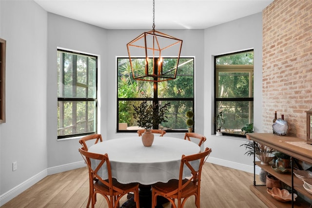 12705 Green Heron Way, Odessa, FL 33556 - dining room featuring light wood-style flooring, a chandelier, and baseboards