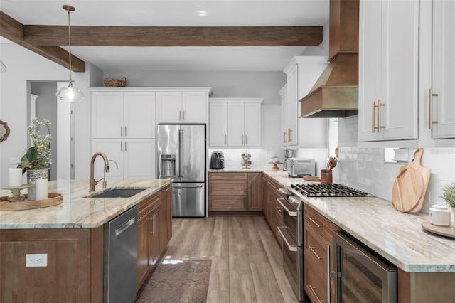 12705 Green Heron Way, Odessa, FL 33556 - kitchen with stainless steel appliances, wall chimney exhaust hood, wine cooler, beamed ceiling, and a sink