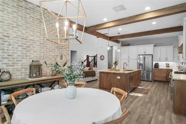 12705 Green Heron Way, Odessa, FL 33556 - dining area with beamed ceiling, light wood-style flooring, recessed lighting, and a chandelier