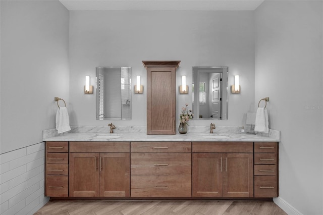 12705 Green Heron Way, Odessa, FL 33556 - full bathroom featuring double vanity and wood finished floors