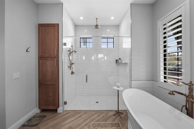 12705 Green Heron Way, Odessa, FL 33556 - full bath with plenty of natural light, wood finished floors, a stall shower, a soaking tub, and recessed lighting