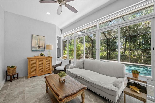 12705 Green Heron Way, Odessa, FL 33556 - living area with healthy amount of natural light, a ceiling fan, light stone finish floors, and baseboards