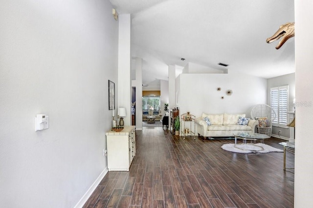 living room featuring healthy amount of natural light, baseboards, and wood finished floors
