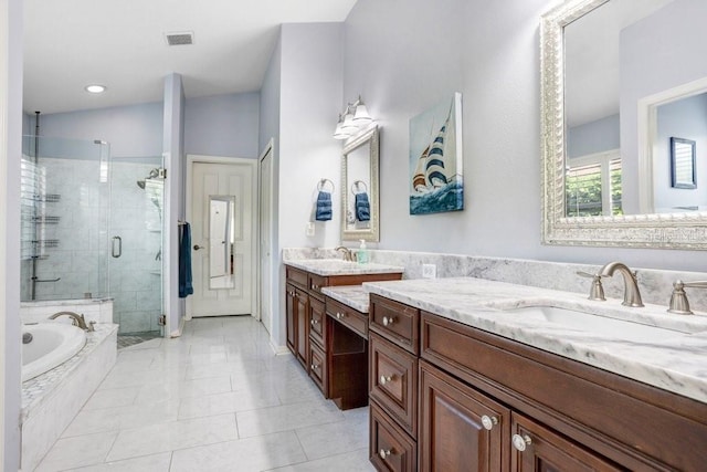 bathroom featuring a garden tub, a stall shower, tile patterned floors, and vanity