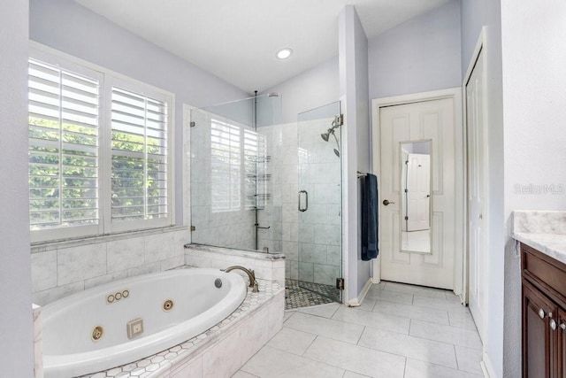 full bathroom with vanity, a stall shower, a tub with jets, tile patterned floors, and baseboards