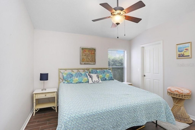bedroom featuring baseboards, wood finished floors, and a ceiling fan