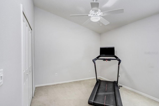workout area with carpet flooring, ceiling fan, baseboards, and vaulted ceiling