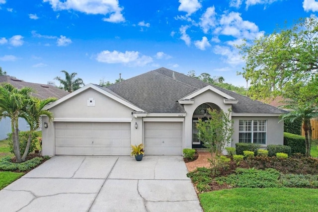 ranch-style house featuring an attached garage, stucco siding, concrete driveway, and a shingled roof
