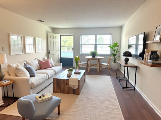 living room with dark wood-style floors and baseboards