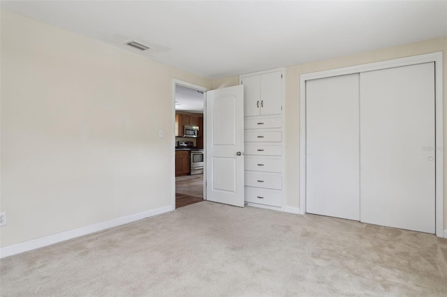 2814 W Humphrey St, Tampa, FL 33614 - unfurnished bedroom with light carpet, a closet, and baseboards