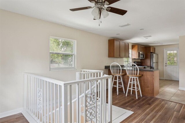2814 W Humphrey St, Tampa, FL 33614 - kitchen with appliances with stainless steel finishes, dark countertops, brown cabinetry, and baseboards