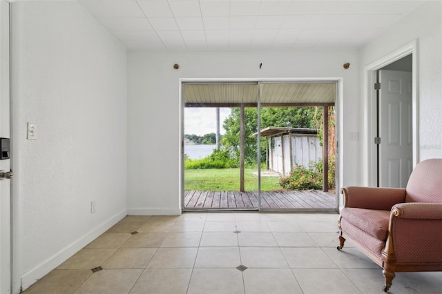 2814 W Humphrey St, Tampa, FL 33614 - living area with light tile patterned floors, a water view, and baseboards