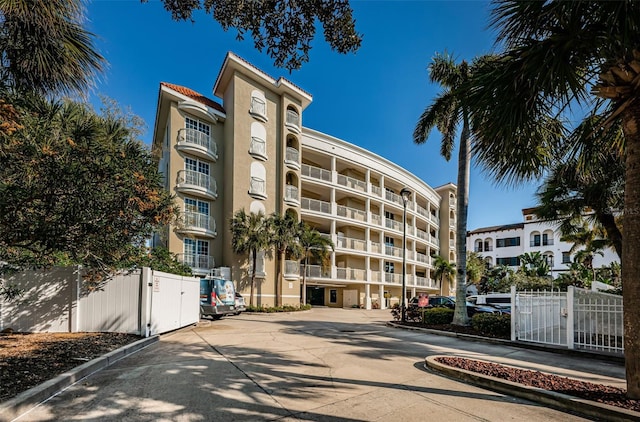 view of apartment building / complex featuring fence