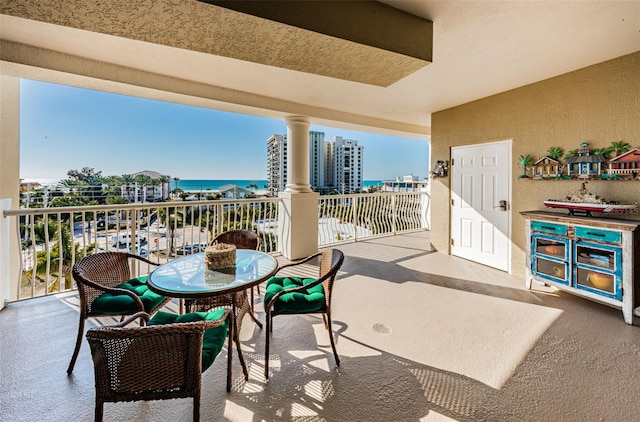 view of patio / terrace featuring a balcony and a water view