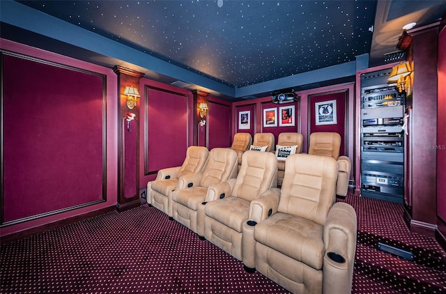 carpeted cinema featuring baseboards