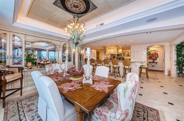 dining room with a raised ceiling, a chandelier, and recessed lighting