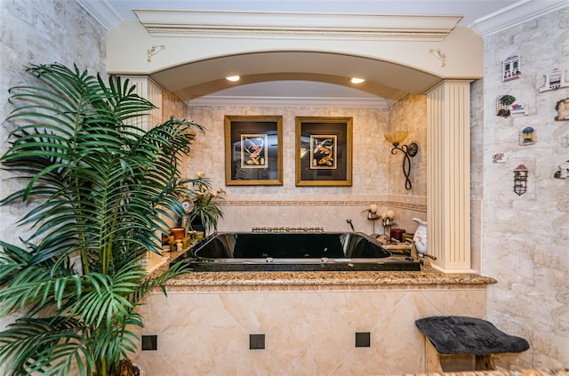 bathroom featuring crown molding and a tub with jets