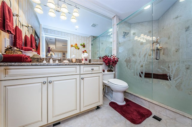 bathroom with a stall shower, vanity, and toilet