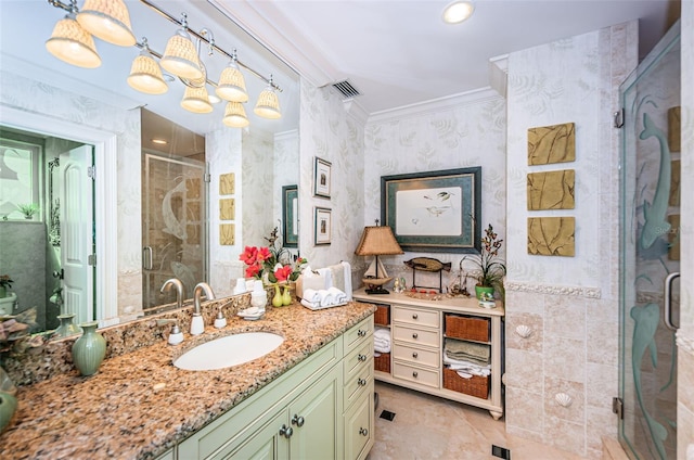 bathroom featuring a shower stall, vanity, crown molding, wallpapered walls, and tile patterned floors