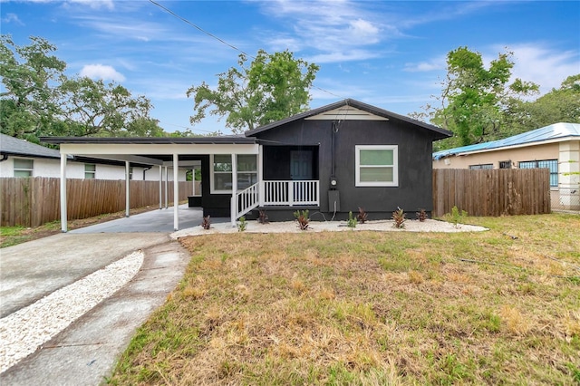 1914 E Emma St, Tampa, FL 33610 - view of front facade with driveway, an attached carport, and a sunroom