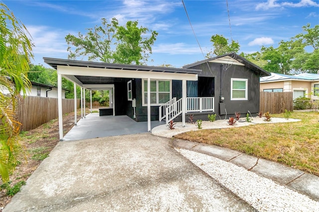 1914 E Emma St, Tampa, FL 33610 - view of front of house with fence, concrete driveway, and an attached carport