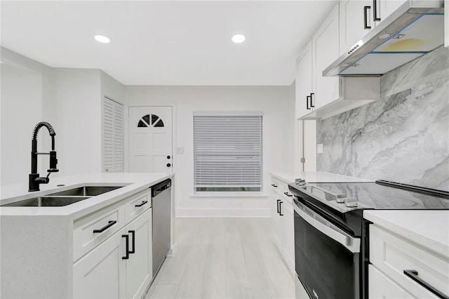 1914 E Emma St, Tampa, FL 33610 - kitchen featuring appliances with stainless steel finishes, under cabinet range hood, a sink, light countertops, and recessed lighting