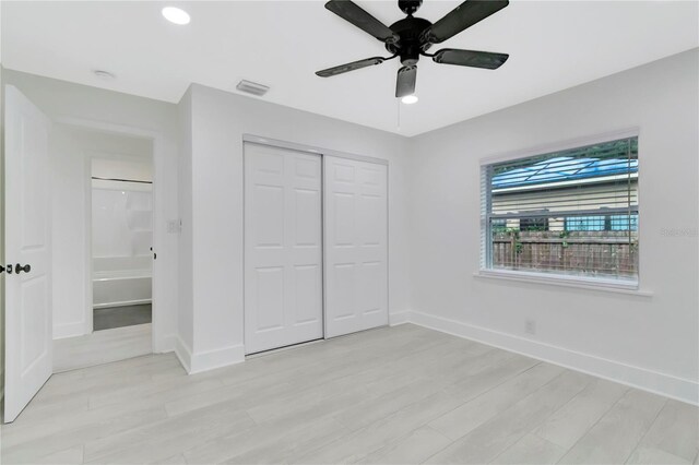 1914 E Emma St, Tampa, FL 33610 - unfurnished bedroom featuring light wood-style floors, baseboards, a closet, ceiling fan, and recessed lighting