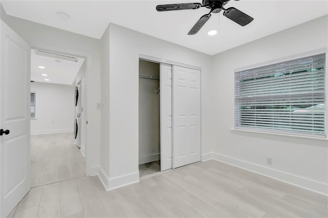 1914 E Emma St, Tampa, FL 33610 - unfurnished bedroom with stacked washing machine and dryer, a closet, baseboards, ceiling fan, and recessed lighting