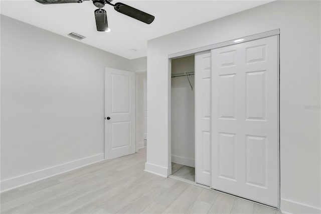 1914 E Emma St, Tampa, FL 33610 - unfurnished bedroom with baseboards, light wood finished floors, a closet, and ceiling fan