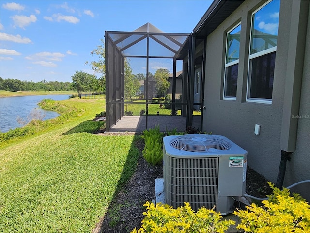 3776 Maxwell Park Dr, Sun City Center, FL 33573 - view of grassy yard with central AC, a water view, and a lanai