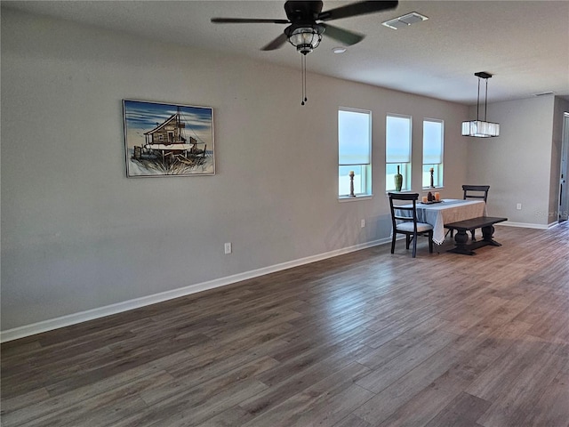 3776 Maxwell Park Dr, Sun City Center, FL 33573 - dining space featuring dark wood-type flooring, baseboards, and ceiling fan