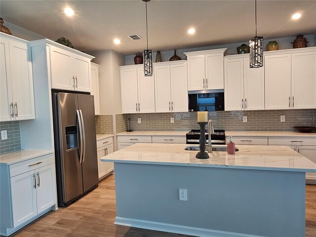 3776 Maxwell Park Dr, Sun City Center, FL 33573 - kitchen featuring stainless steel fridge with ice dispenser, light wood-type flooring, black microwave, backsplash, and a sink
