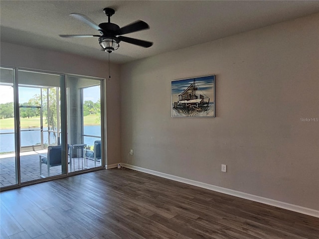 3776 Maxwell Park Dr, Sun City Center, FL 33573 - unfurnished room with dark wood-style flooring, baseboards, and a ceiling fan
