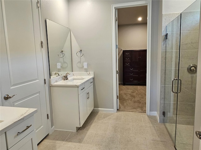3776 Maxwell Park Dr, Sun City Center, FL 33573 - full bathroom with vanity, a stall shower, baseboards, tile patterned flooring, and a spacious closet