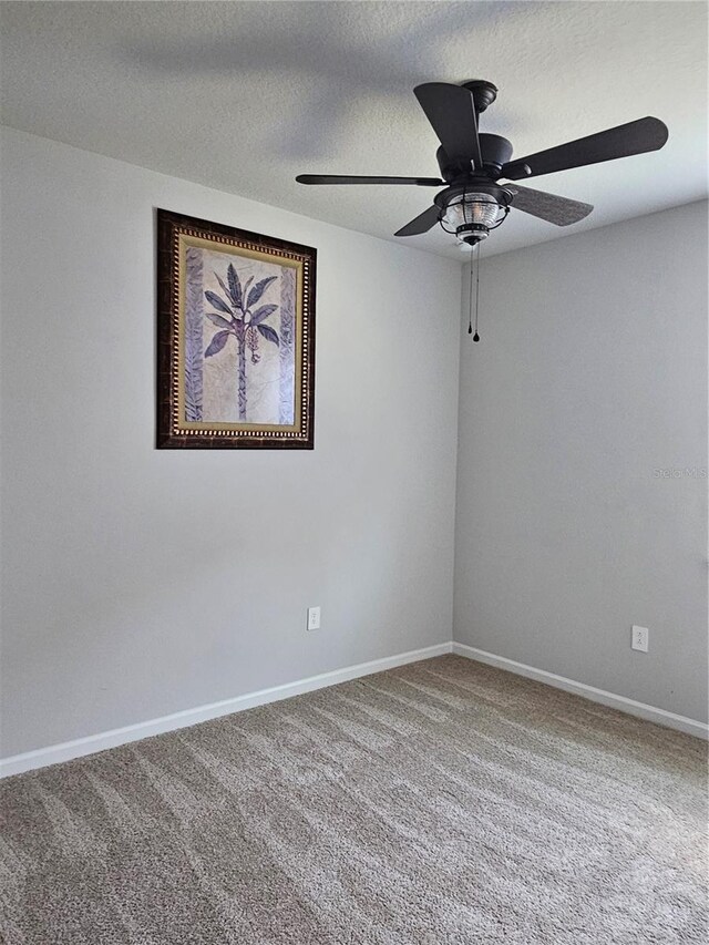 3776 Maxwell Park Dr, Sun City Center, FL 33573 - empty room with carpet flooring, a ceiling fan, baseboards, and a textured ceiling