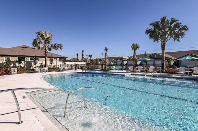 3776 Maxwell Park Dr, Sun City Center, FL 33573 - community pool featuring a patio and a residential view