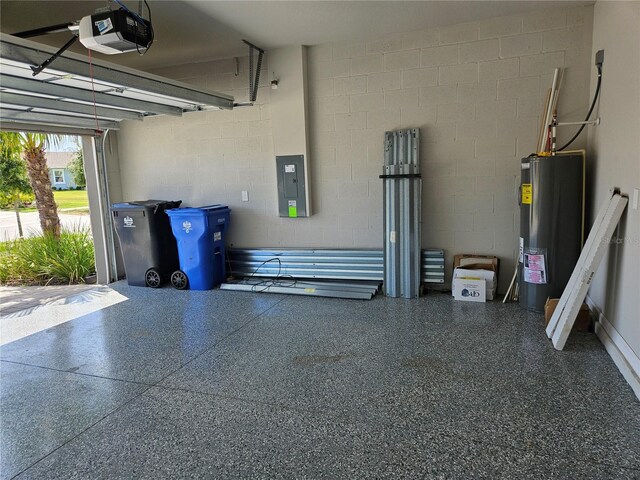 3776 Maxwell Park Dr, Sun City Center, FL 33573 - garage with a garage door opener, water heater, electric panel, and concrete block wall