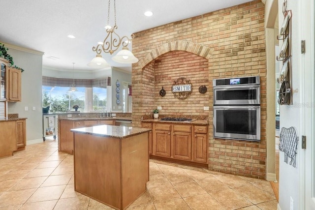 2502 Fritzke Rd, Dover, FL 33527 - kitchen with a kitchen island, appliances with stainless steel finishes, light tile patterned floors, stone counters, and brick wall