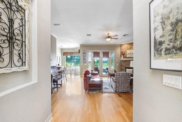 2502 Fritzke Rd, Dover, FL 33527 - living area featuring a textured wall, a fireplace, wood finished floors, a ceiling fan, and crown molding