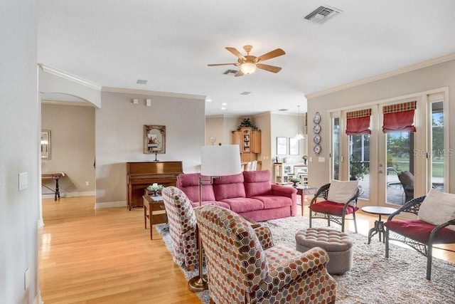 2502 Fritzke Rd, Dover, FL 33527 - living area with french doors, crown molding, arched walkways, a ceiling fan, and light wood-style floors