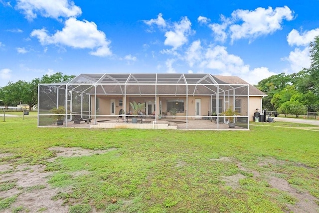 2502 Fritzke Rd, Dover, FL 33527 - back of property with a lawn, a patio, stucco siding, and a lanai