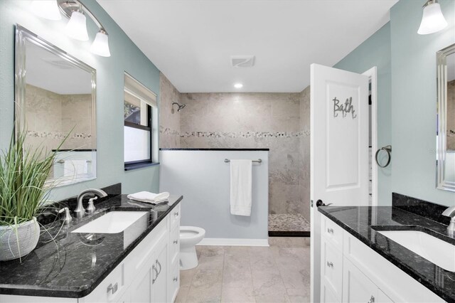 2287 Demaret Dr, Dunedin, FL 34698 - full bathroom with walk in shower, two vanities, and toilet
