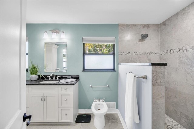 2287 Demaret Dr, Dunedin, FL 34698 - bathroom with walk in shower, vanity, a bidet, and baseboards