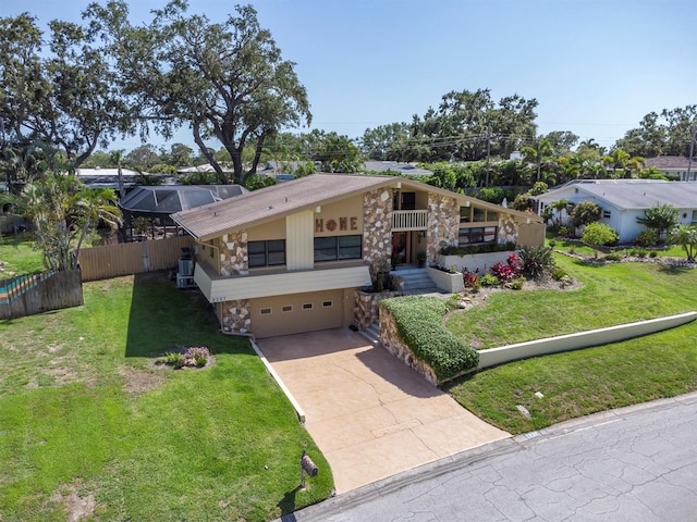 2287 Demaret Dr, Dunedin, FL 34698 - mid-century home featuring a garage and concrete driveway