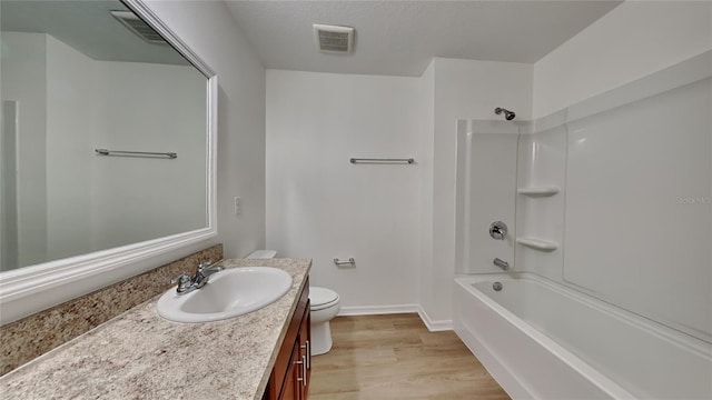 full bath featuring toilet, wood finished floors, vanity, shower / bath combination, and baseboards
