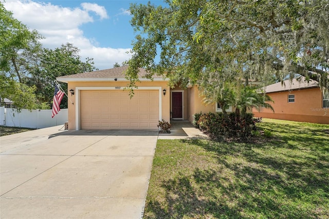 9917 Prevatt St, Gibsonton, FL 33534 - view of front of home featuring stucco siding, a garage, and concrete driveway