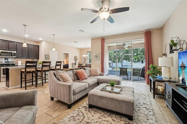 9917 Prevatt St, Gibsonton, FL 33534 - living room featuring a ceiling fan, light tile patterned floors, a textured ceiling, and recessed lighting