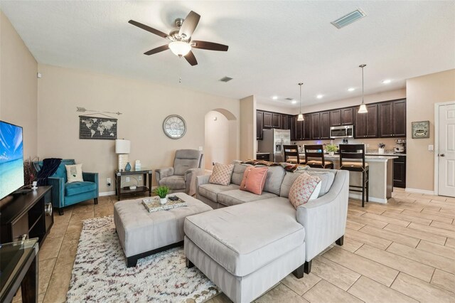 9917 Prevatt St, Gibsonton, FL 33534 - living area with a ceiling fan, arched walkways, recessed lighting, and baseboards