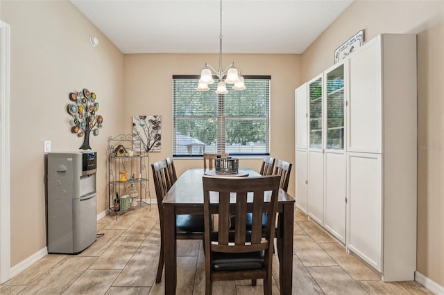 9917 Prevatt St, Gibsonton, FL 33534 - dining space featuring a chandelier, light tile patterned floors, and baseboards